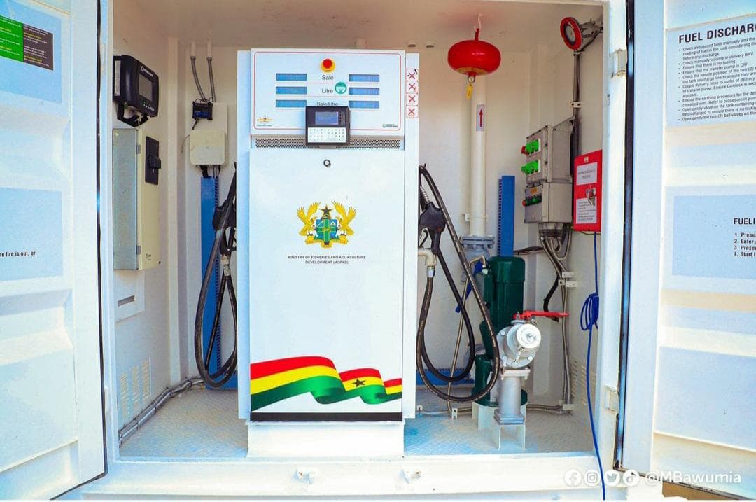 Automated fuel dispenser installed inside a white station kiosk