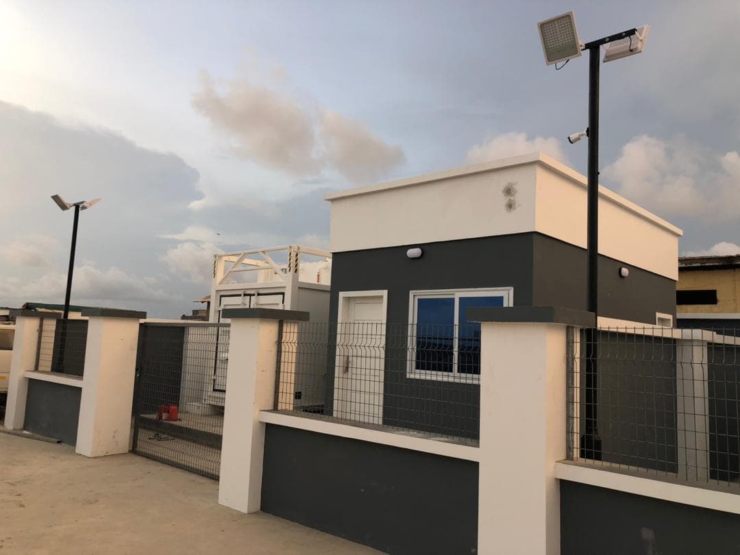 Exterior of a dark grey premix fuel station building at dusk